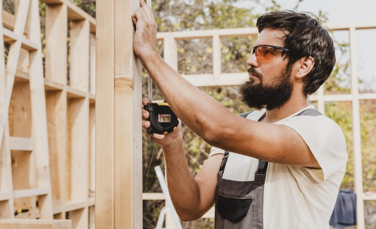 carpenter man using tape measure